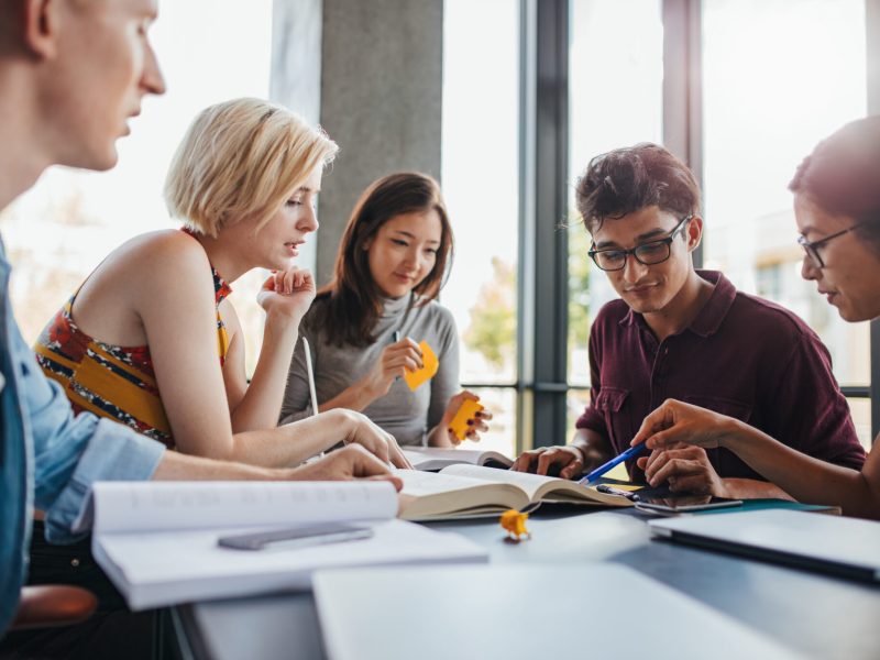 Diverse group of students studying at library