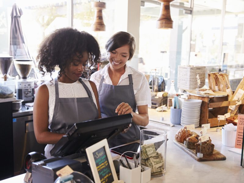 New Employee Receives Training At Delicatessen Checkout