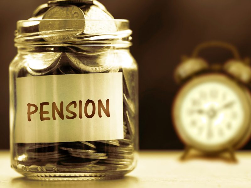 Close up Coins in glass jar for giving and pension concept , dar