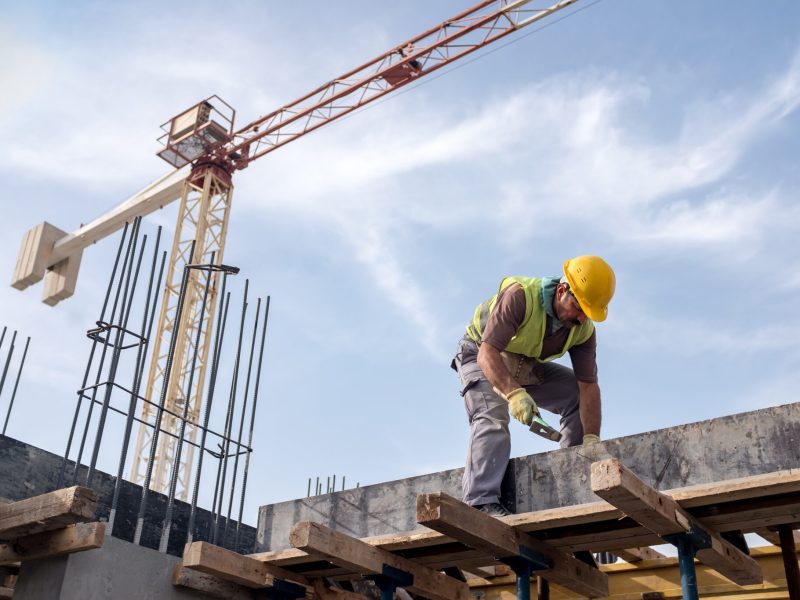 Worker At Construction Site Is Fixing The Form For The Beam