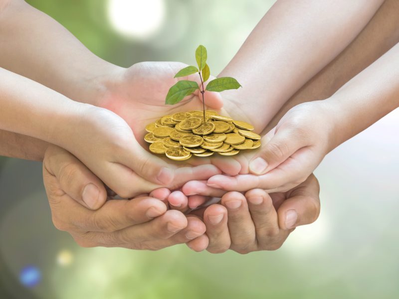 Retirement planning, family financial investment and legacy concept with father parent support children's hands growing tree with wealthy gold coins