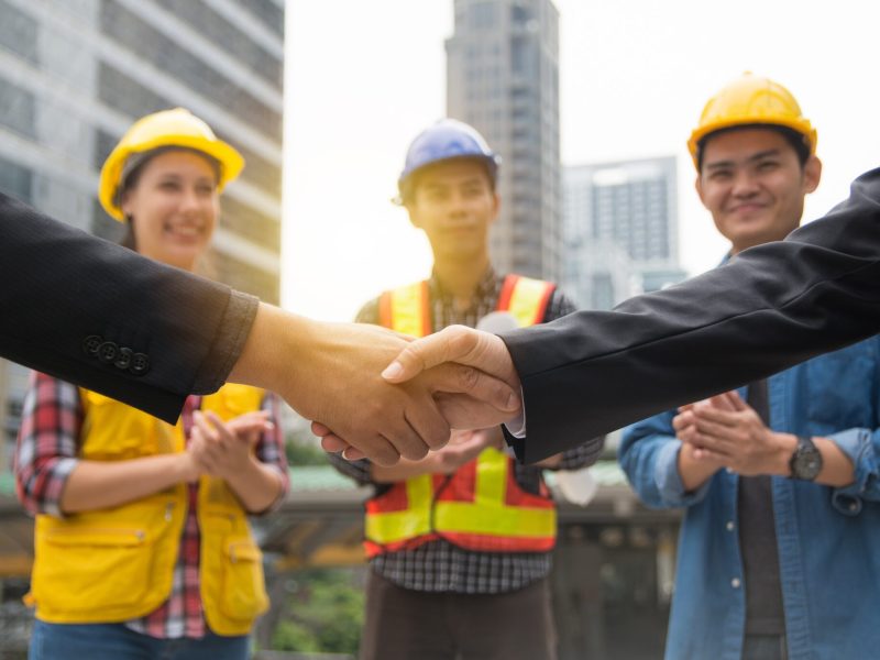 Businessman shake hand with engineers celebrating success