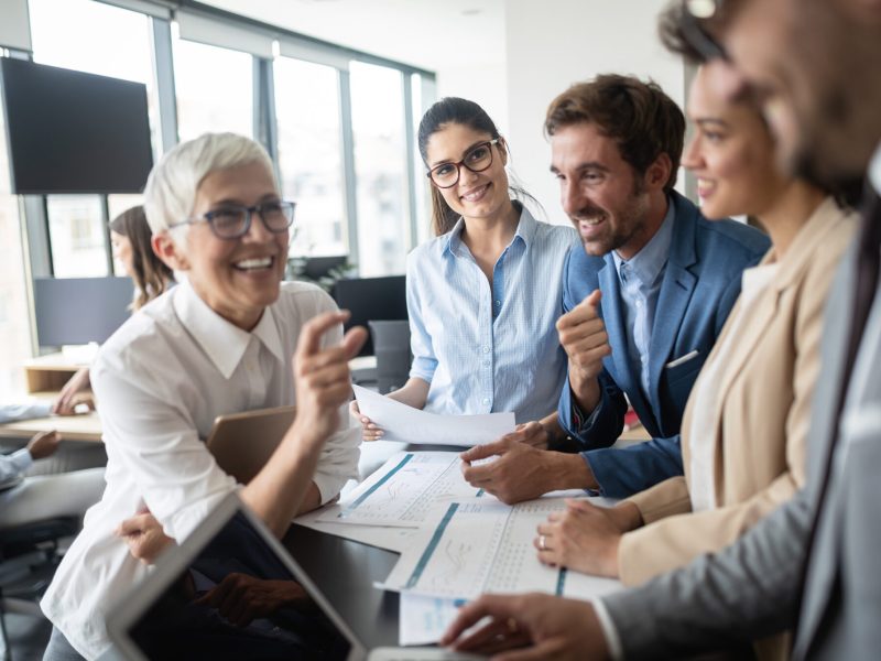 Group of young business people working and communicating at the office