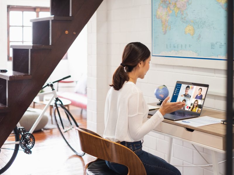 Young Asian businesswoman work at home and virtual video conference meeting with colleagues business people, online working, video call due to social distancing at home office