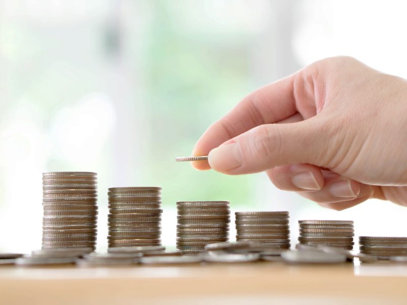 Hand human hand putting coin to money, business ideas