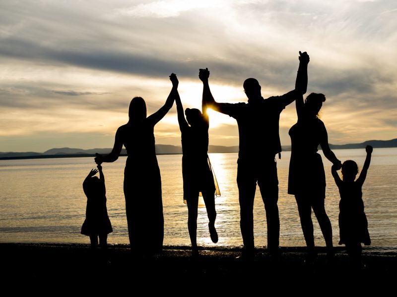 six family member at beach silhouette sunset