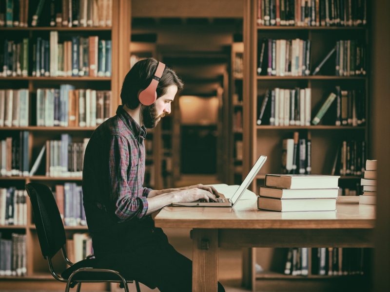 Hipster student studying in library