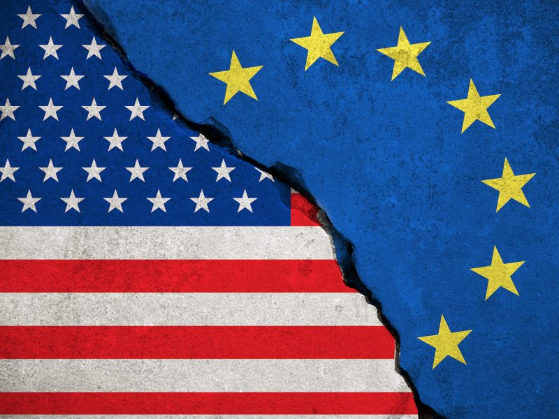 blue european union EU flag on broken wall and half usa united states of america flag, crisis trump president and europe euro