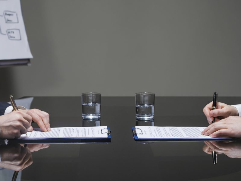 Businessmen signing contracts