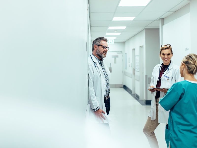 Medical team discussing in corridor at hospital