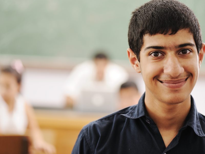 Young student in classroom in college