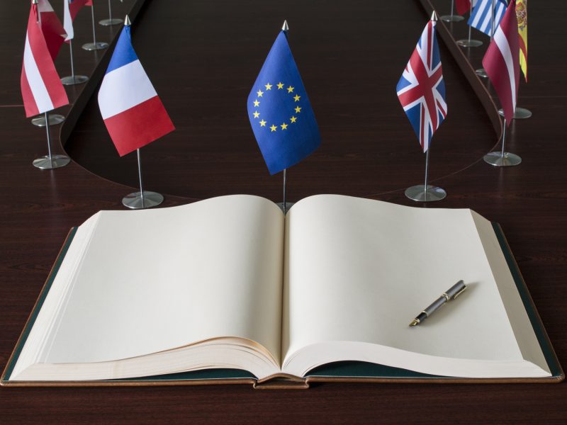 Open spread book, fountain pen, EU (European Union) flags