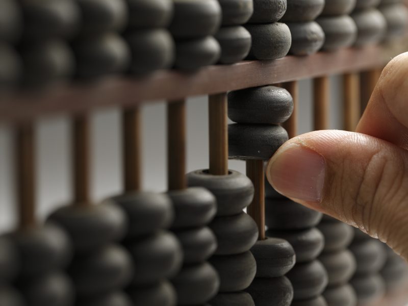 Man hands are operating abacus