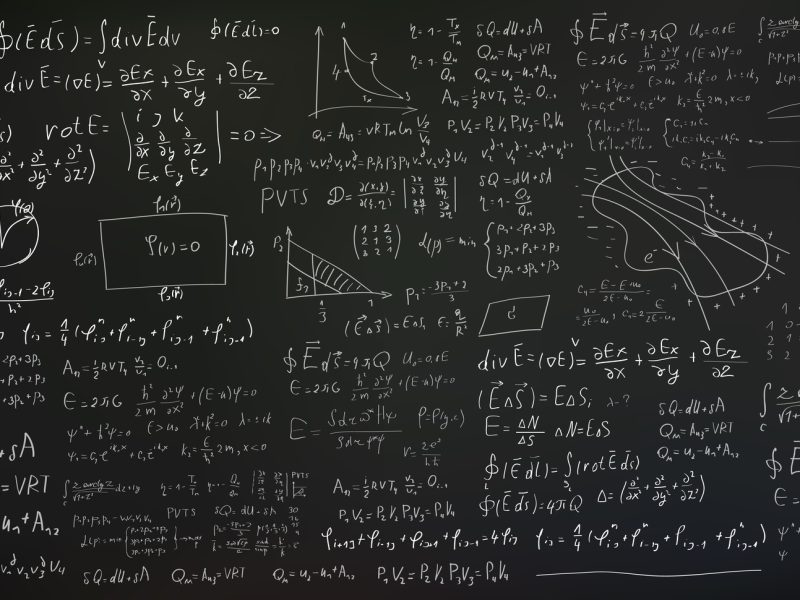 Handwritten formulas and equations on black background