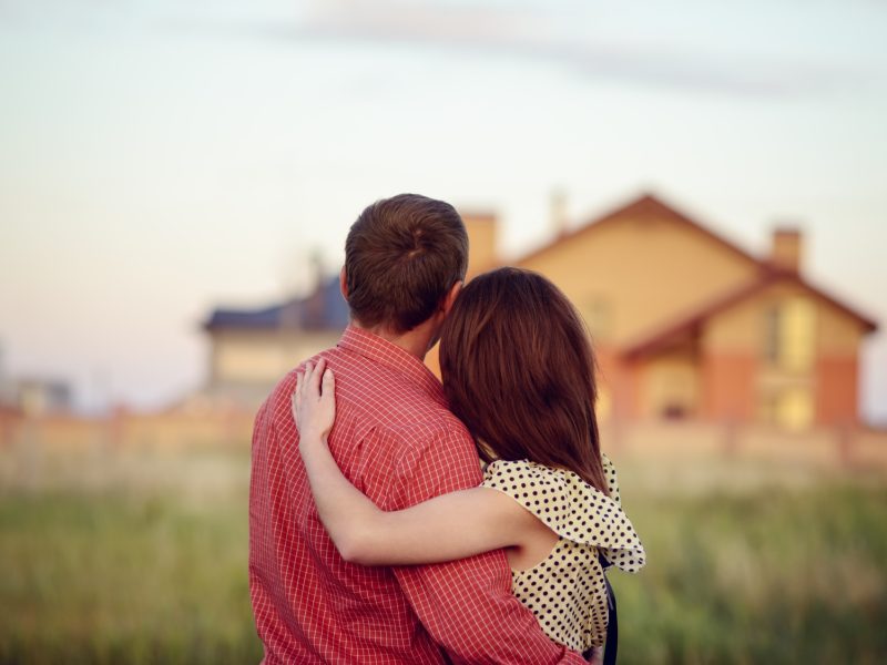 loving couple looking at their home