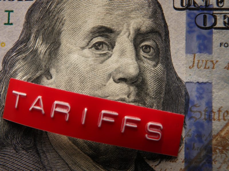 Red Tariffs label on a hundred dollar bill