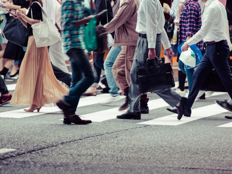 Asian People are across the crosswalk