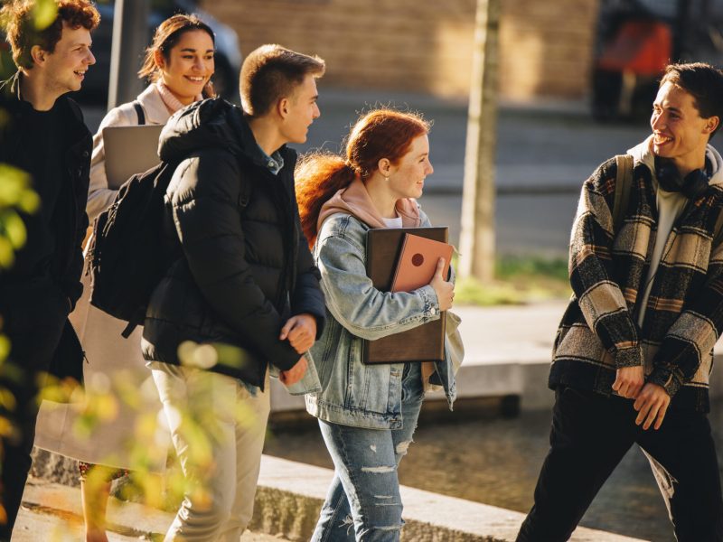 Young people walking outside after class