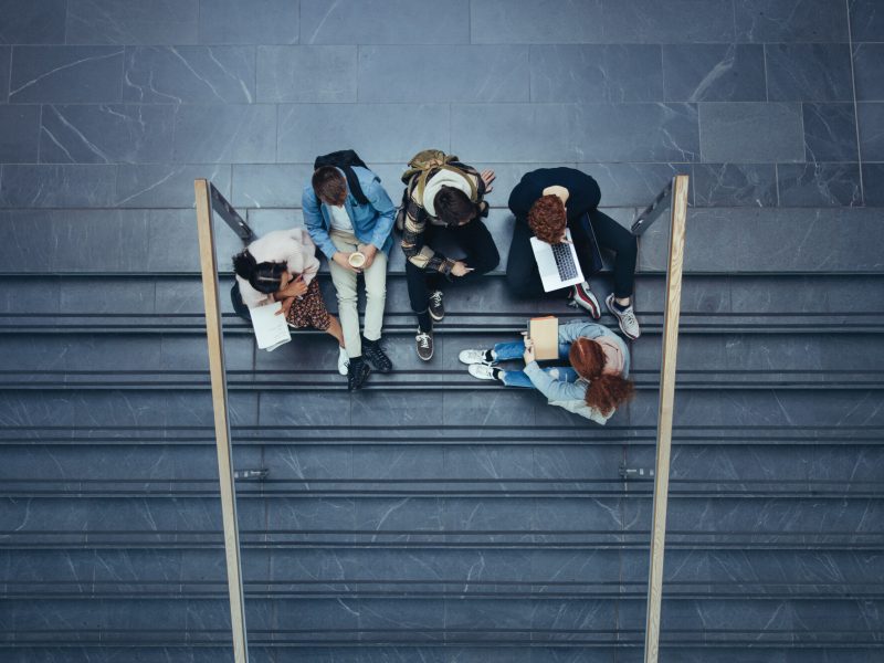 Students sitting in college campus