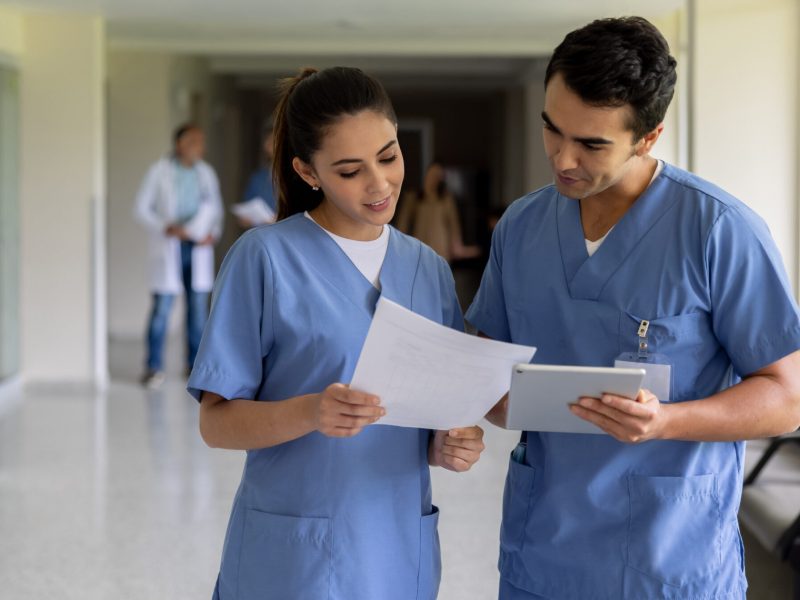 Team of doctors working at the hospital and looking at some documents